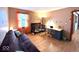 A well-lit bedroom featuring fun wall decals, wood flooring and a futon at 7621 Forest Dr, Fishers, IN 46038