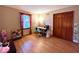 Cozy bedroom featuring a study desk and lots of natural light with access to storage closet and window views at 7621 Forest Dr, Fishers, IN 46038