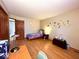 Cozy bedroom featuring unique wall decals, wood flooring and natural light at 7621 Forest Dr, Fishers, IN 46038