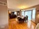 Open concept kitchen and dining area with wood floors and a view to the fireplace in the living room at 7621 Forest Dr, Fishers, IN 46038