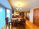 Bright dining room featuring wood floors and a modern chandelier fixture at 7621 Forest Dr, Fishers, IN 46038