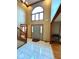 Bright foyer featuring tiled floors, a grand staircase, and ample natural light through a large arched window at 7621 Forest Dr, Fishers, IN 46038