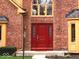 Close-up of the home's front entrance, highlighting the brick facade, large front door and well-maintained lawn at 7621 Forest Dr, Fishers, IN 46038