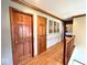 Hallway with wood floors and multiple doors, connecting different areas of the home at 7621 Forest Dr, Fishers, IN 46038