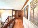 Well-lit hallway featuring stylish palm tree wall decor and elegant wood trim, leading to other areas of the house at 7621 Forest Dr, Fishers, IN 46038