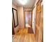 Hallway with hardwood floors and access to other rooms, offering seamless transitions at 7621 Forest Dr, Fishers, IN 46038