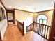 Bright hallway with hardwood floors, leading to the staircase and other rooms at 7621 Forest Dr, Fishers, IN 46038