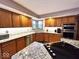 Open kitchen features wood cabinets, granite counters, tiled backsplash and stainless appliances at 7621 Forest Dr, Fishers, IN 46038