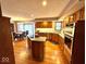 Spacious kitchen featuring an island with granite countertops and wooden cabinetry at 7621 Forest Dr, Fishers, IN 46038