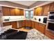 Open kitchen features wood cabinets, granite counters, tiled backsplash and stainless appliances at 7621 Forest Dr, Fishers, IN 46038