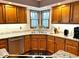 Open kitchen features wood cabinets, granite counters, tiled backsplash and stainless appliances at 7621 Forest Dr, Fishers, IN 46038