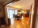 Open kitchen and dining area featuring hardwood floors, updated appliances, and large windows at 7621 Forest Dr, Fishers, IN 46038