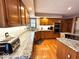 Open kitchen features wood cabinets, granite counters, tiled backsplash and stainless appliances at 7621 Forest Dr, Fishers, IN 46038