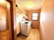 Laundry room with washer, dryer, and storage shelf, providing convenience at 7621 Forest Dr, Fishers, IN 46038