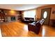Spacious living room features hardwood floors, a brick fireplace, and comfortable seating at 7621 Forest Dr, Fishers, IN 46038