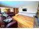 Open-concept living room with hardwood floors, fireplace, and seamless access to the kitchen at 7621 Forest Dr, Fishers, IN 46038