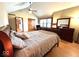 Cozy main bedroom with wood floors, ceiling fan, and an attached hallway at 7621 Forest Dr, Fishers, IN 46038