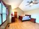 A charming main bedroom with hardwood floors, vaulted ceilings, and a bright window at 7621 Forest Dr, Fishers, IN 46038