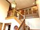 An elegant foyer and staircase featuring wood trim and a decorative chandelier at 7621 Forest Dr, Fishers, IN 46038