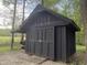 Barn featuring large sliding doors and an attached covered area at 7916 N Lasalle Rd, Morgantown, IN 46160