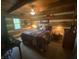 Spacious bedroom featuring log walls, warm lighting, and cozy furnishings at 7916 N Lasalle Rd, Morgantown, IN 46160