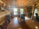 Cozy dining area with wood accents, stone fireplace, and natural light from large windows at 7916 N Lasalle Rd, Morgantown, IN 46160