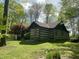 Charming log home featuring a covered front porch and well-maintained lawn at 7916 N Lasalle Rd, Morgantown, IN 46160