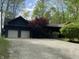Charming log home with two-car garage, gravel driveway, manicured front yard, and mature trees and plantings at 7916 N Lasalle Rd, Morgantown, IN 46160
