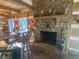 Cozy cabin living room with a stone fireplace, wood beam ceilings, and rustic accents at 7916 N Lasalle Rd, Morgantown, IN 46160