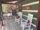 Inviting cabin porch featuring rocking chairs and rustic decor; ideal spot for relaxation at 7916 N Lasalle Rd, Morgantown, IN 46160