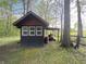 Well-maintained shed with a covered area for storage; a lawn mower sits nearby at 7916 N Lasalle Rd, Morgantown, IN 46160
