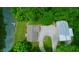 Aerial view of the house, barn, and pond, nestled amongst lush green trees at 8310 Goat Hollow Rd, Martinsville, IN 46151