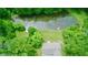 Aerial view of house and pond with the surrounding property, showcasing the lush, wooded landscape at 8310 Goat Hollow Rd, Martinsville, IN 46151