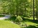 Landscaped backyard features mature trees and lawn at 8310 Goat Hollow Rd, Martinsville, IN 46151