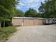 Large, storage barn with gravel parking and trailer, surrounded by a lush green lawn at 8310 Goat Hollow Rd, Martinsville, IN 46151