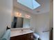 Well-lit bathroom featuring a skylight and modern fixtures for a refreshing experience at 8310 Goat Hollow Rd, Martinsville, IN 46151