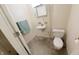 Practical half-bathroom with toilet, sink, and small hand-towel rack at 8310 Goat Hollow Rd, Martinsville, IN 46151