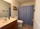 Inviting bathroom with vanity, a towel rack and a shower with blue curtains at 8310 Goat Hollow Rd, Martinsville, IN 46151