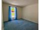 Bright bedroom with blue carpet and curtains, features a window offering natural light at 8310 Goat Hollow Rd, Martinsville, IN 46151