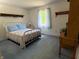 Bedroom with soft blue carpet, large window, and bright natural light at 8310 Goat Hollow Rd, Martinsville, IN 46151
