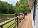 Spacious deck with wooden railings overlooking a pond surrounded by lush greenery and mature trees at 8310 Goat Hollow Rd, Martinsville, IN 46151