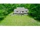Aerial of home with lush green lawn, mature trees and back deck at 8310 Goat Hollow Rd, Martinsville, IN 46151