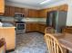 Kitchen with oak cabinets, stainless steel appliances, and dining table with chairs at 8310 Goat Hollow Rd, Martinsville, IN 46151