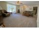 Bright living room with plush carpet, lots of seating, and views from the large front window at 8310 Goat Hollow Rd, Martinsville, IN 46151