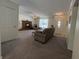 Spacious living room showcasing a cozy fireplace, plush carpeting, and neutral wall color at 8310 Goat Hollow Rd, Martinsville, IN 46151