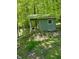 Rustic outbuilding nestled among mature trees, featuring a cozy porch and metal roof at 8310 Goat Hollow Rd, Martinsville, IN 46151