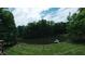 Scenic view of a pond with a dock, surrounded by lush greenery and trees, from the yard at 8310 Goat Hollow Rd, Martinsville, IN 46151
