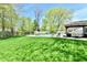 Spacious backyard with a lush lawn, swimming pool, shed, and covered patio area perfect for relaxing at 8548 Scarsdale W Dr, Indianapolis, IN 46256
