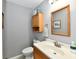 Cozy bathroom with wood cabinet, framed mirror and white sink at 8548 Scarsdale W Dr, Indianapolis, IN 46256