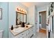 Bathroom featuring a double sink vanity, a light sconce, an a decorative mirror and tiled floor at 8548 Scarsdale W Dr, Indianapolis, IN 46256